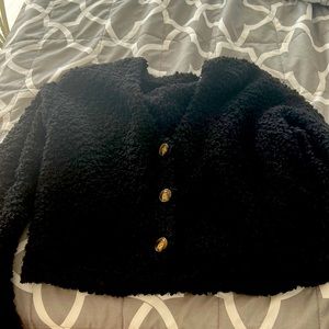 V-neck sweater with buttons down the middle! Was never worn.